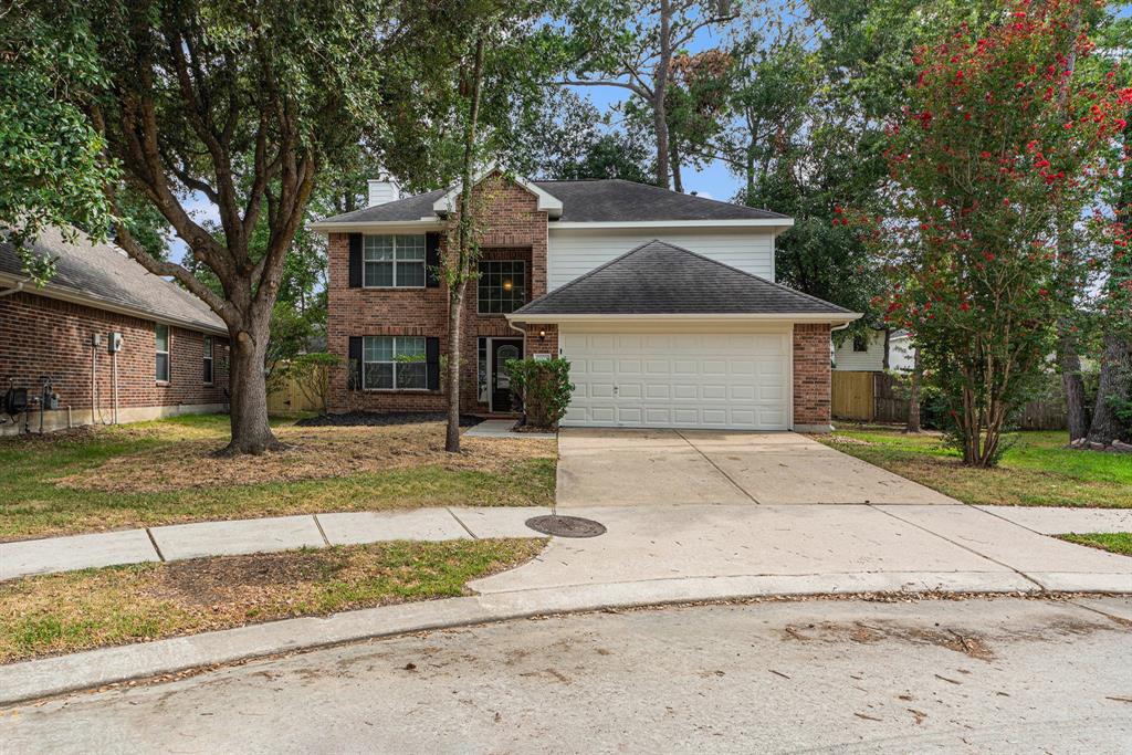 a front view of a house with a yard and a garage