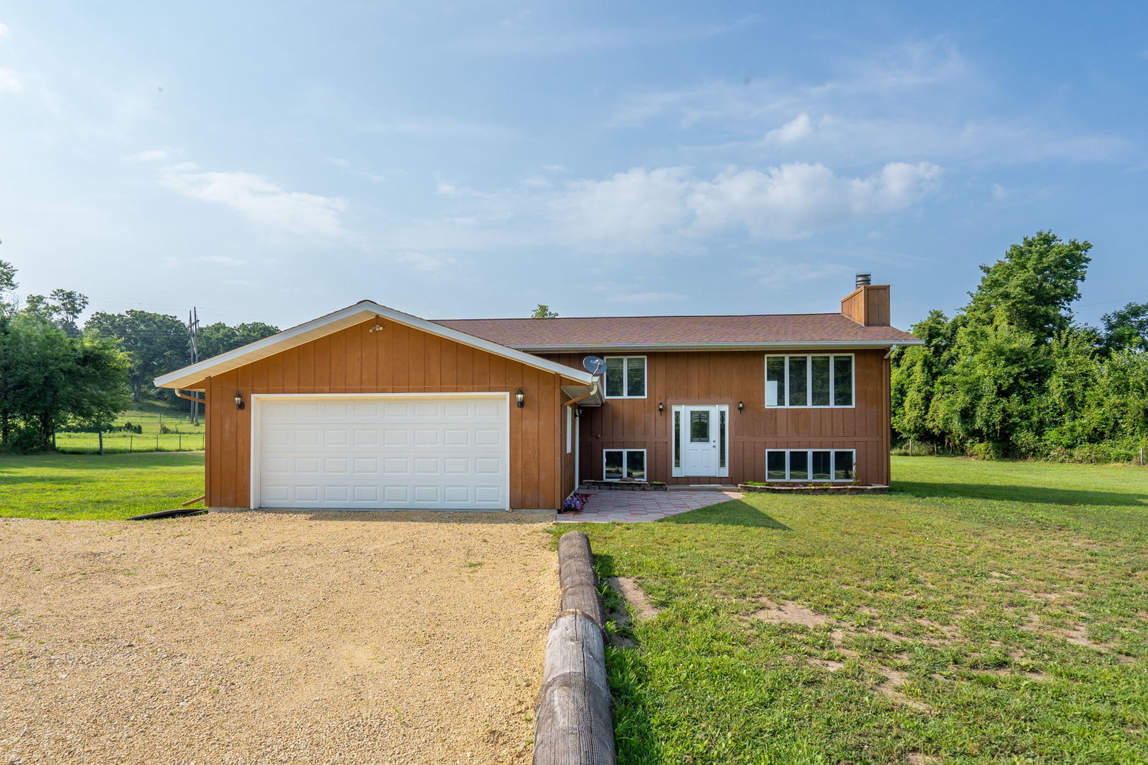 a front view of a house with yard and porch