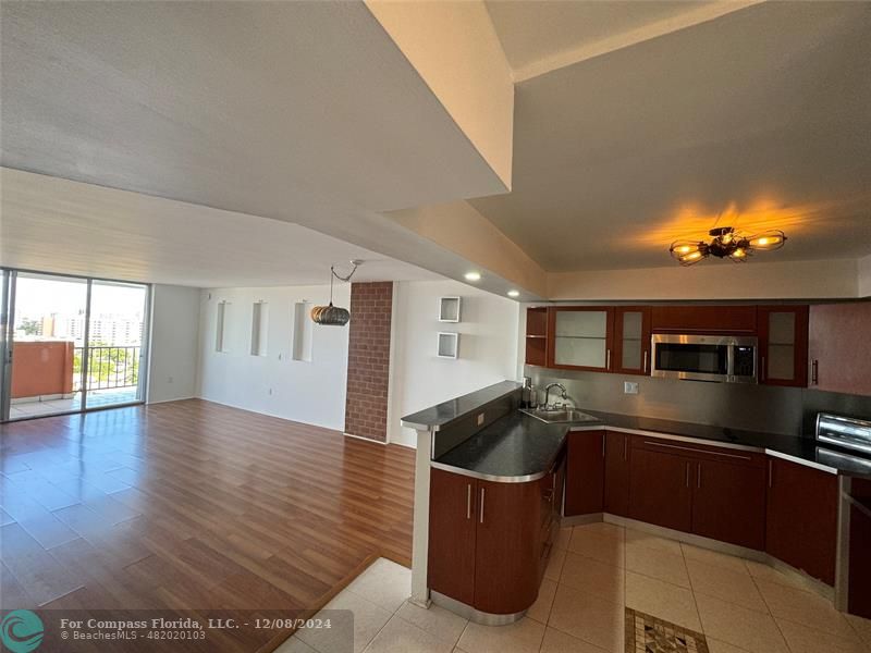 a kitchen with granite countertop a sink and stove