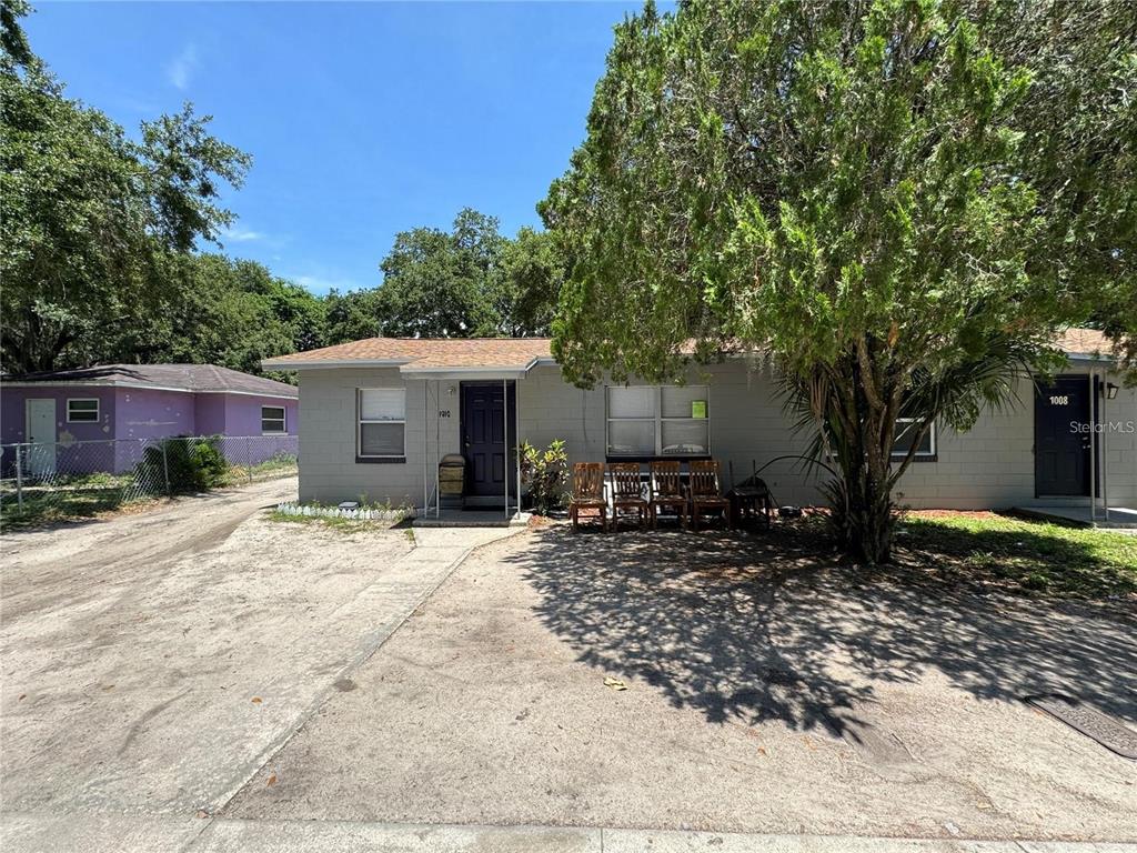 a tree in front of a house