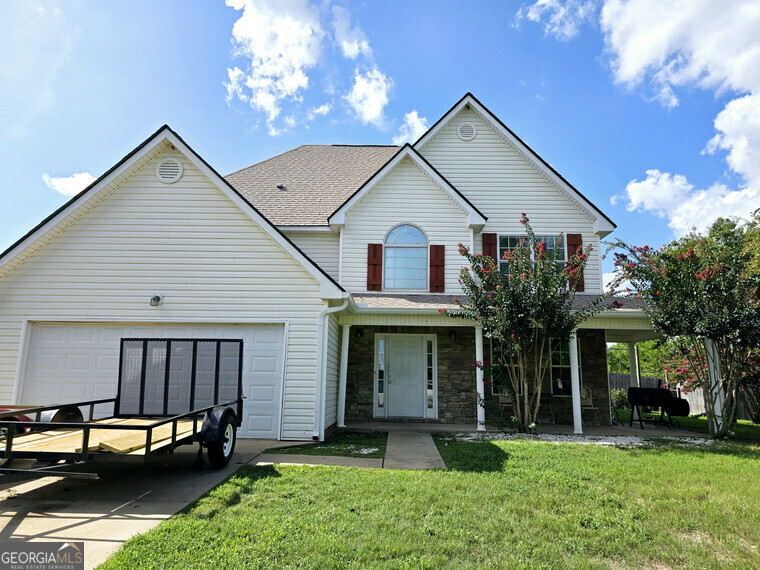 a front view of a house with a yard