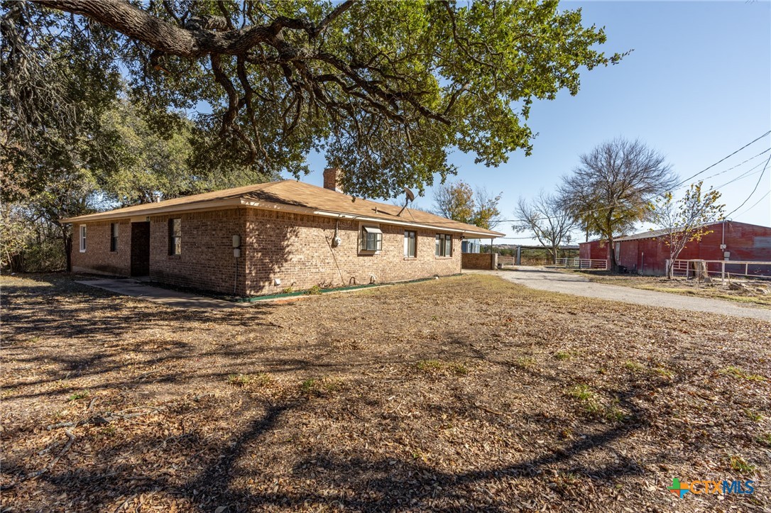 a front view of house with yard and trees around