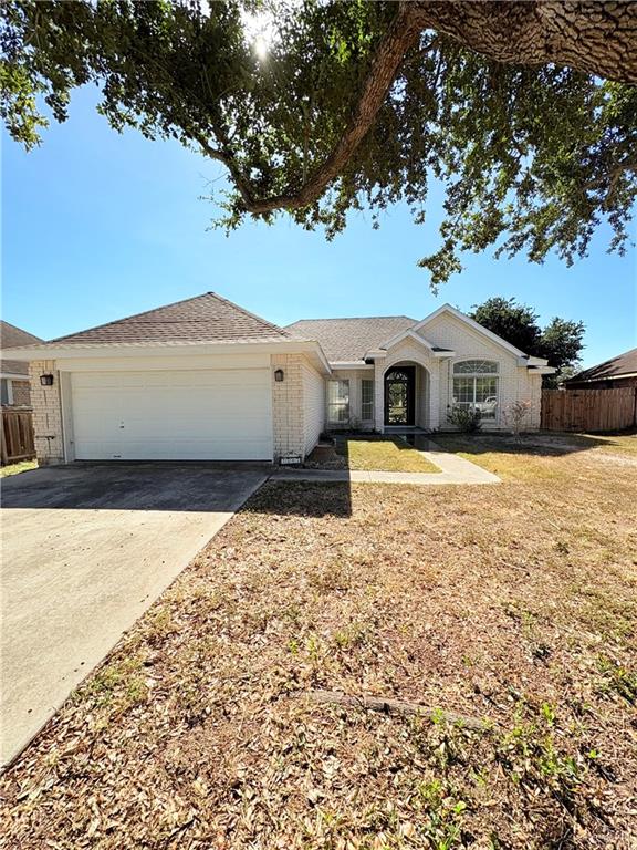 Single story home with a front yard and a garage