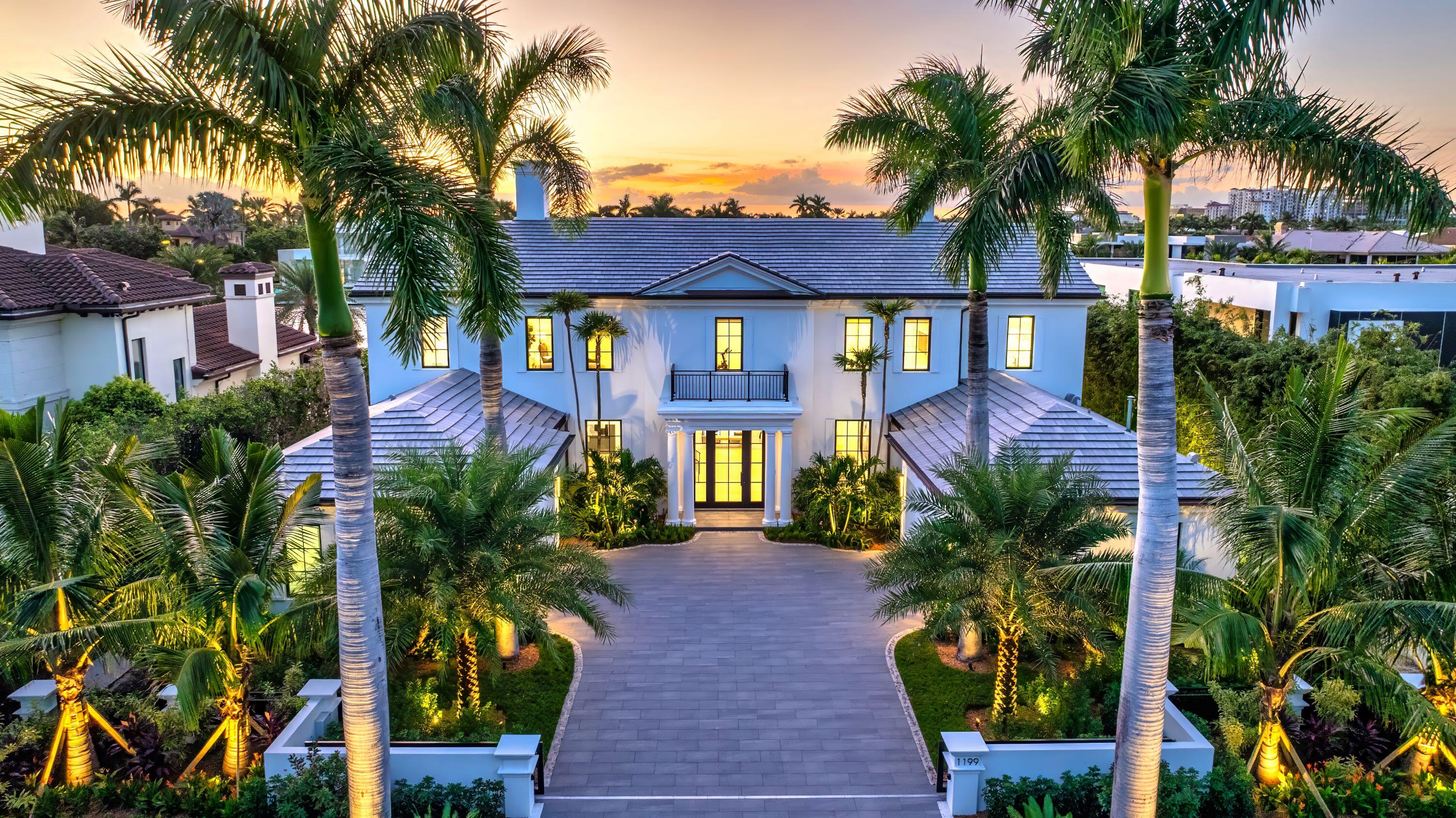 a front view of a house with a yard patio and swimming pool