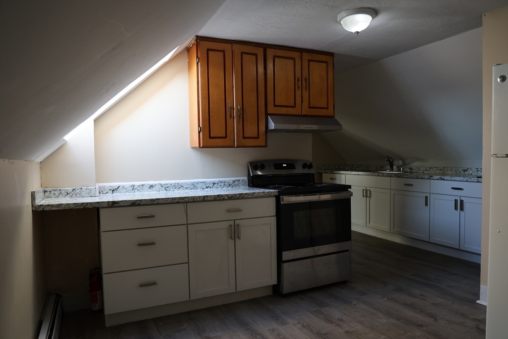 a kitchen with a sink stove and cabinets