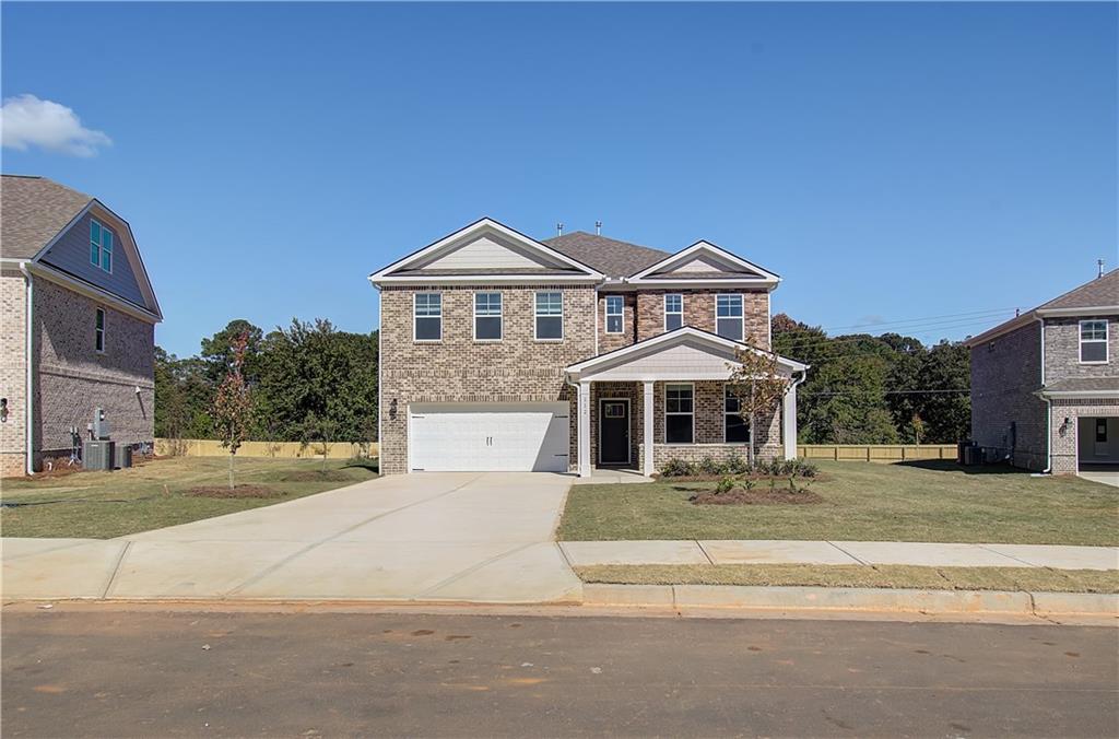 a front view of a house with a yard