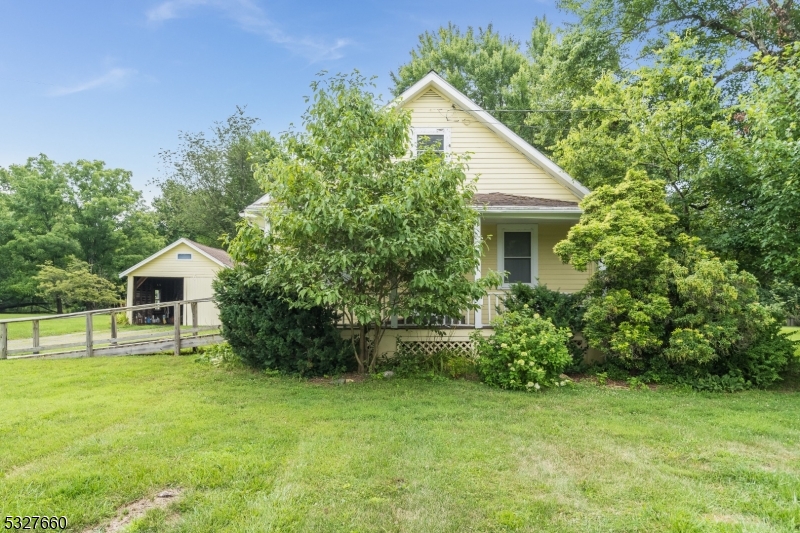 a front view of house with a garden