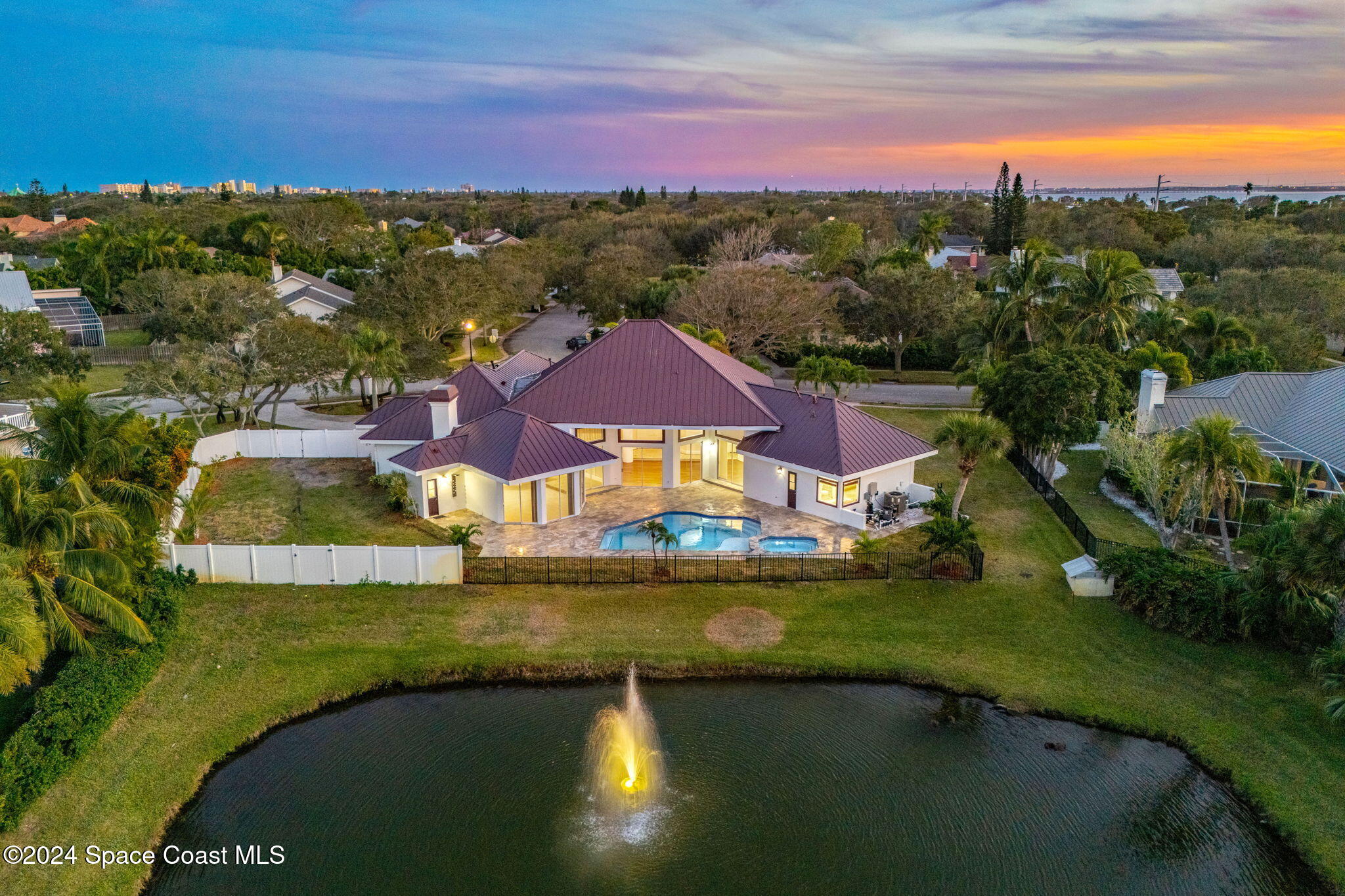 an aerial view of residential houses with outdoor space and lake view