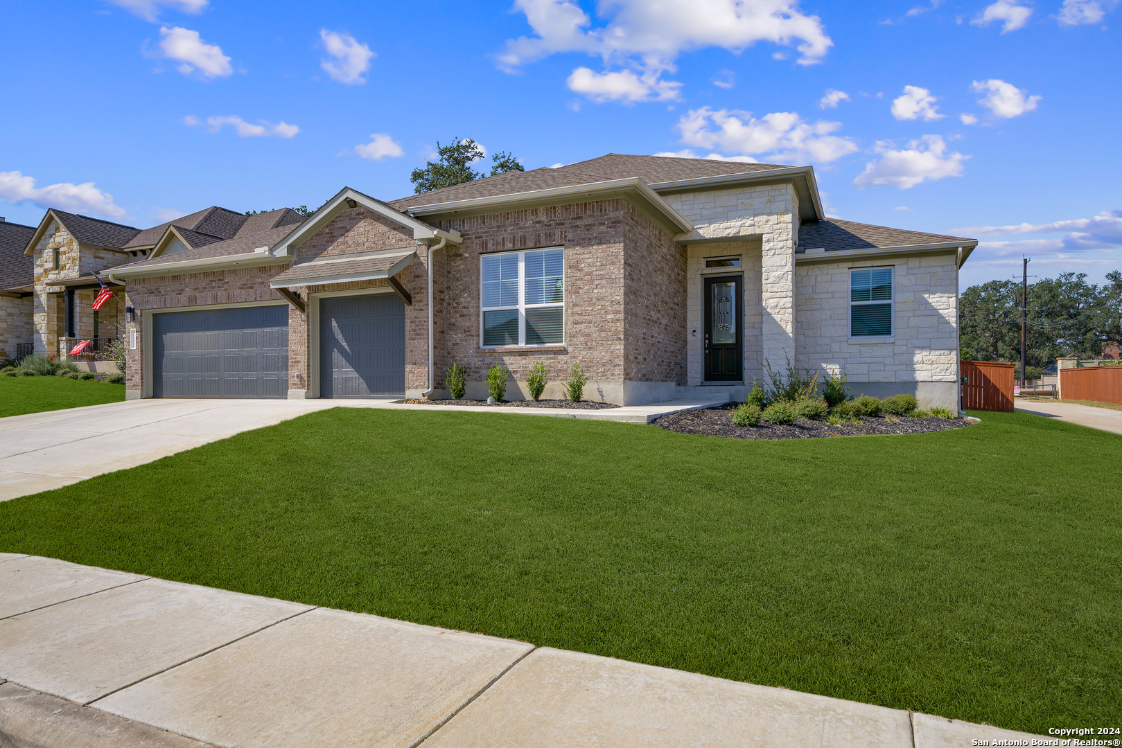 a front view of a house with a garden