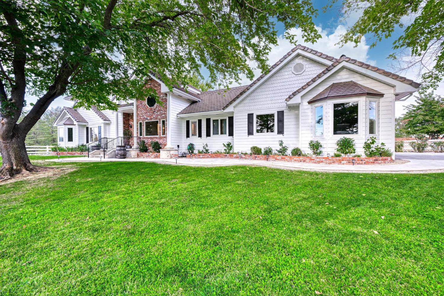 a front view of house with yard and green space