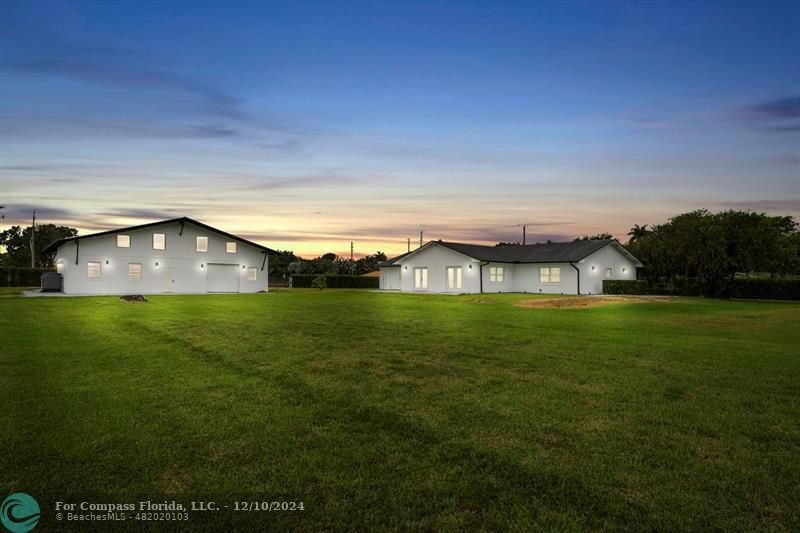 a view of a big house with a big yard