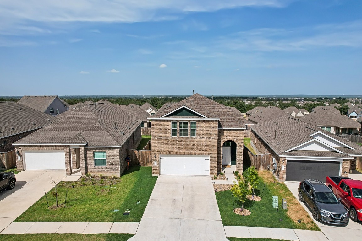 an aerial view of a house with a yard