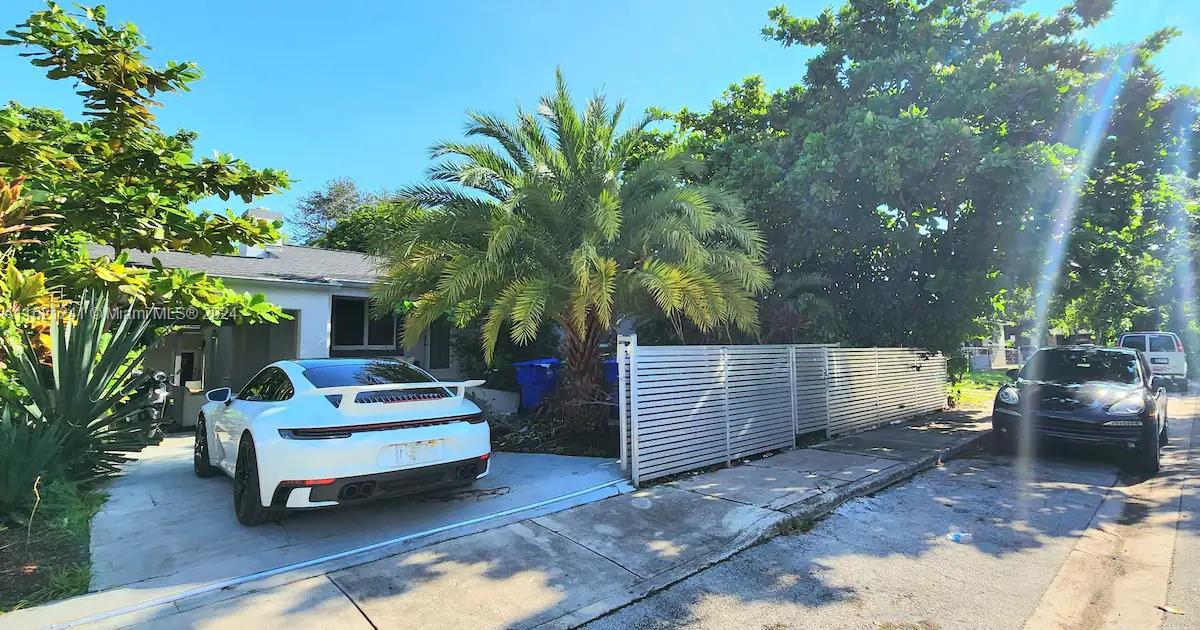 a white bench sitting in backyard of a house