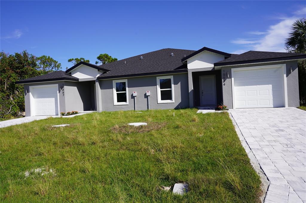 a front view of a house with a garden