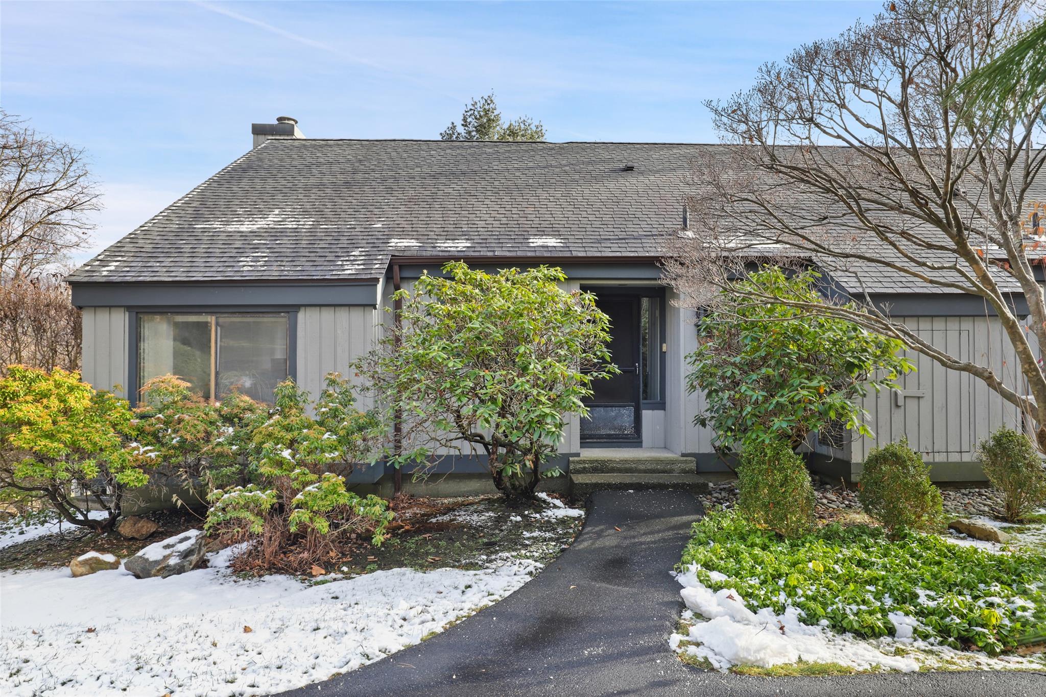 front view of house with potted plants