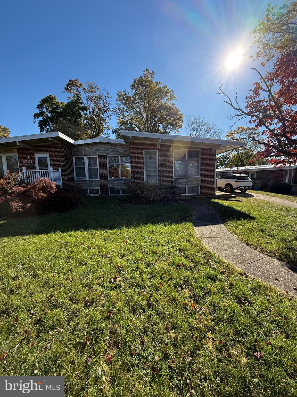 a front view of a house with a garden and yard