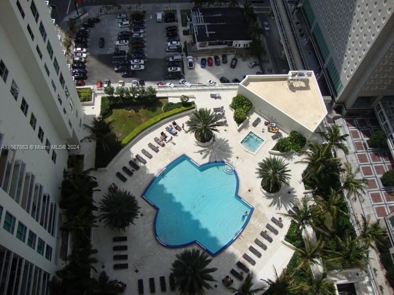 an aerial view of a house with a swimming pool and outdoor seating