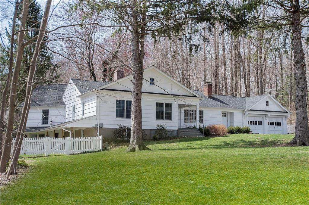 a front view of house with yard and green space