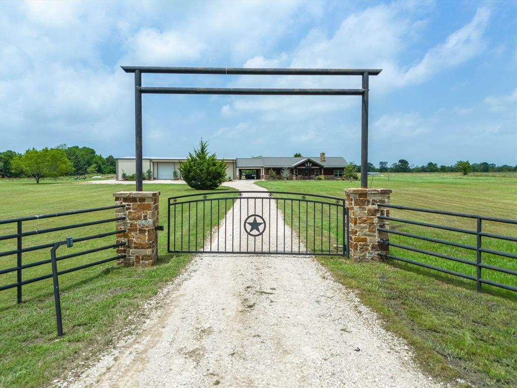 a view of a park with iron fence