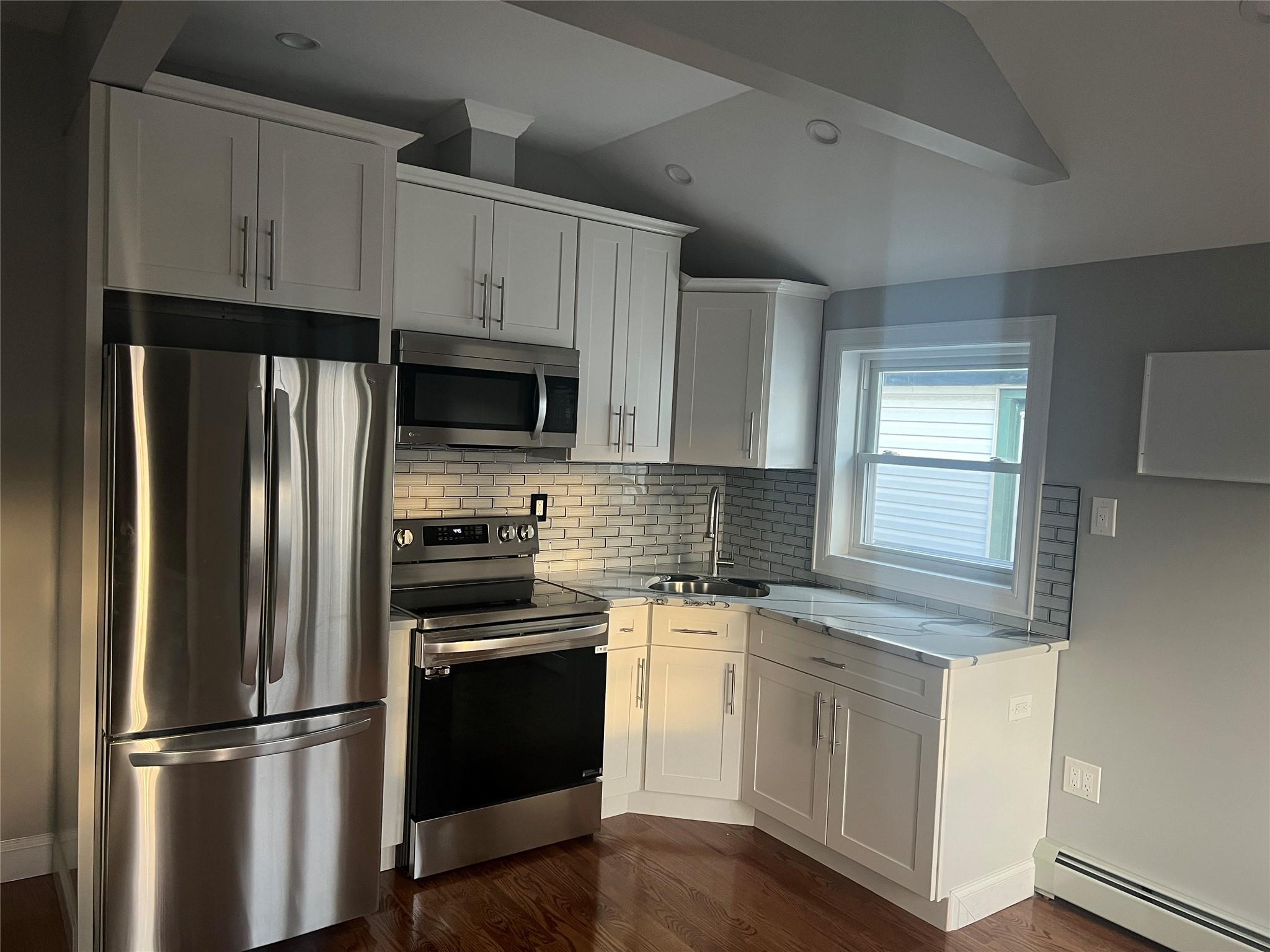 a kitchen with stainless steel appliances white cabinets and a granite counter tops