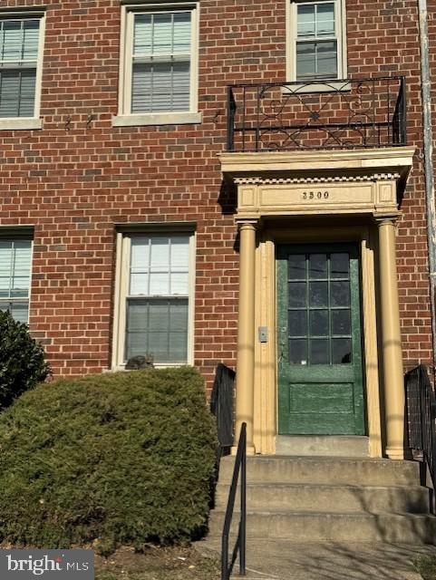 a view of front door of house with stairs