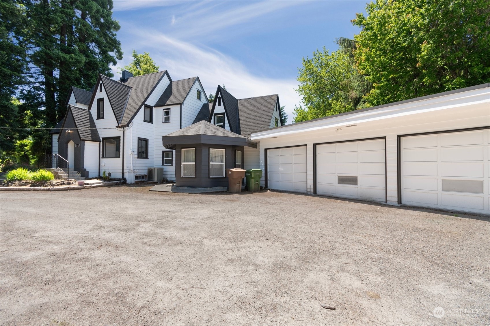 a view of a house with a yard and garage