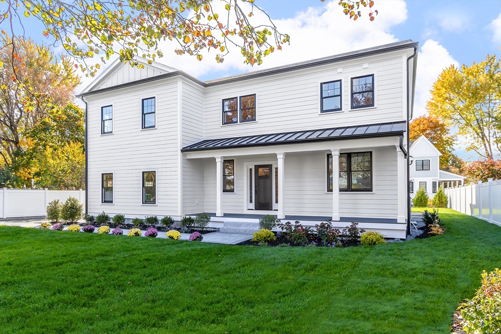 a front view of house with yard and green space