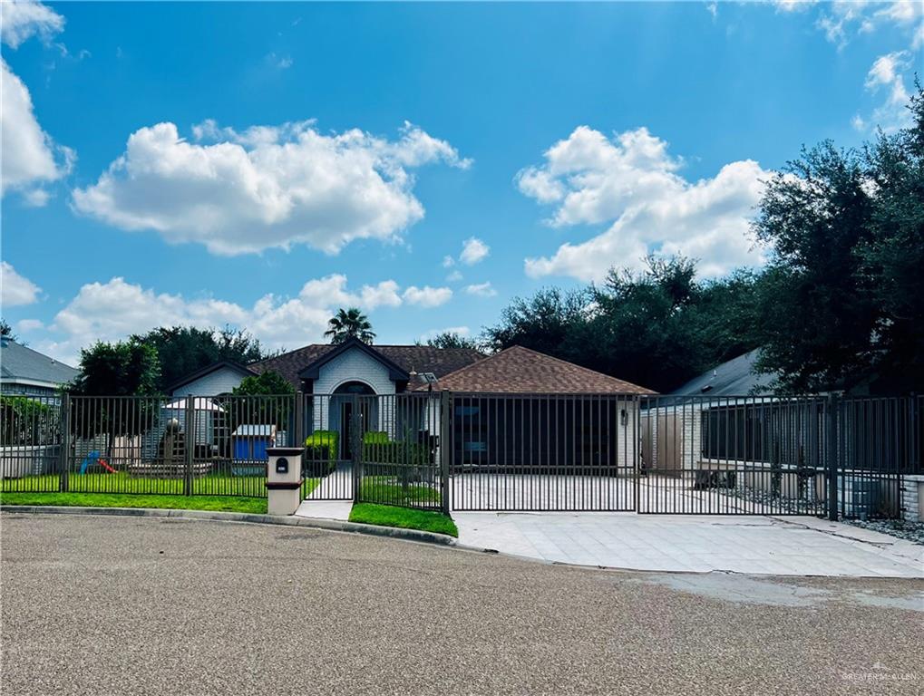 a front view of a house with a garden and plants