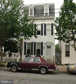 a front view of a house with parking space