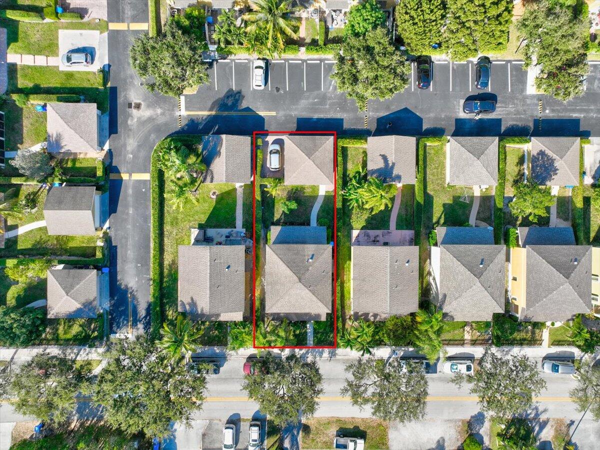 an aerial view of multiple houses with a yard