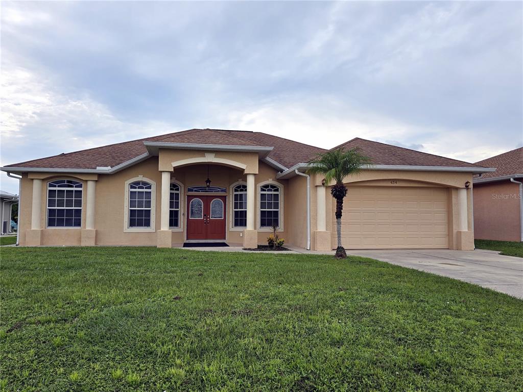 a front view of a house with a yard and garage