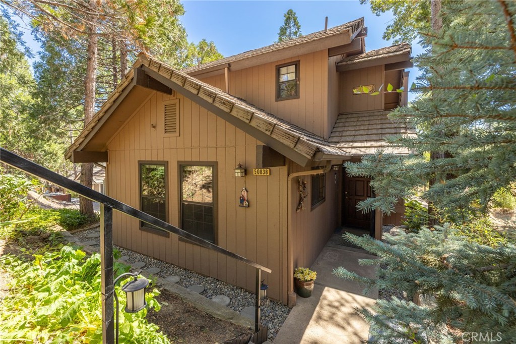 a view of a house with wooden fence