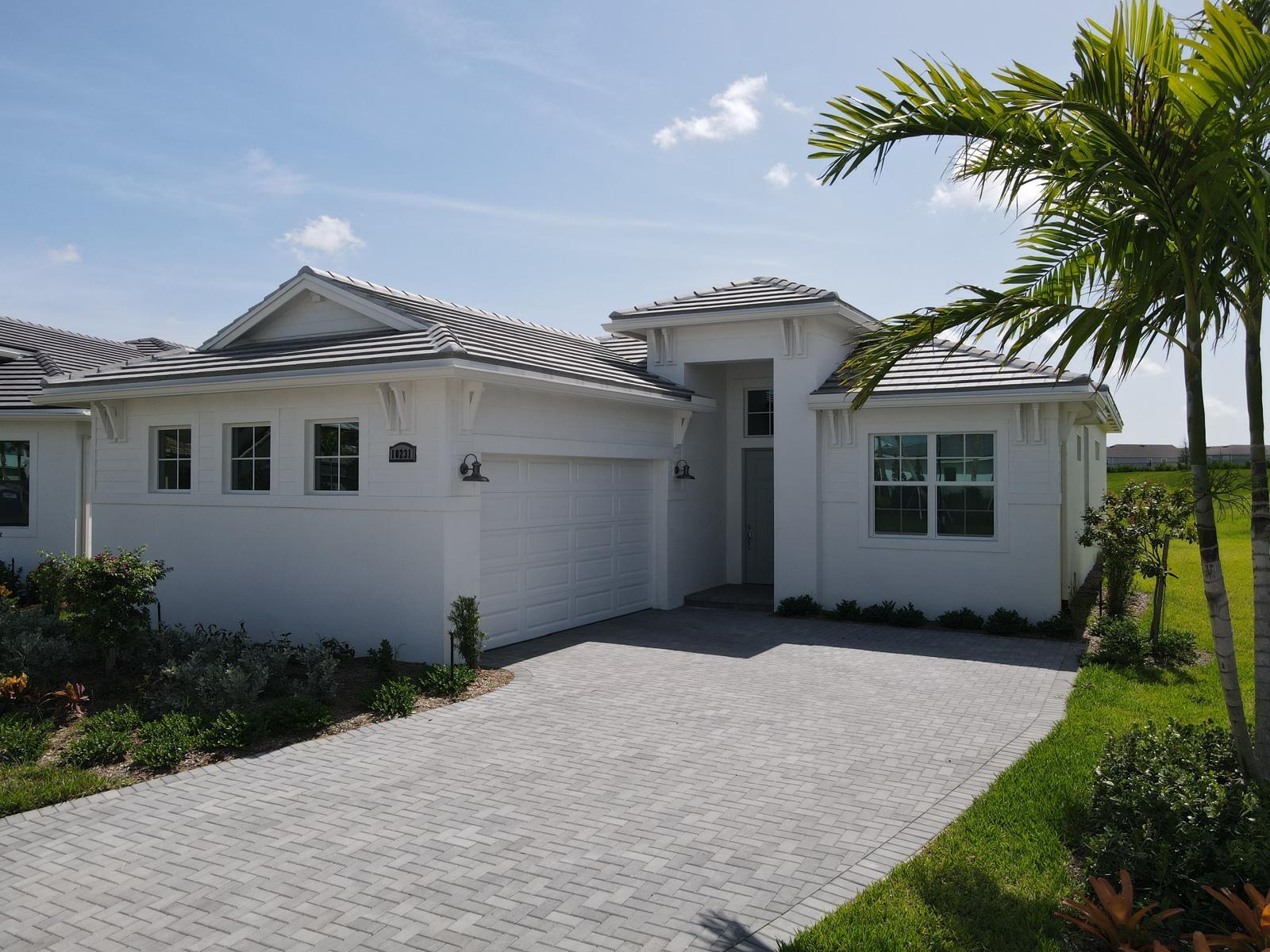 a front view of a house with a garden