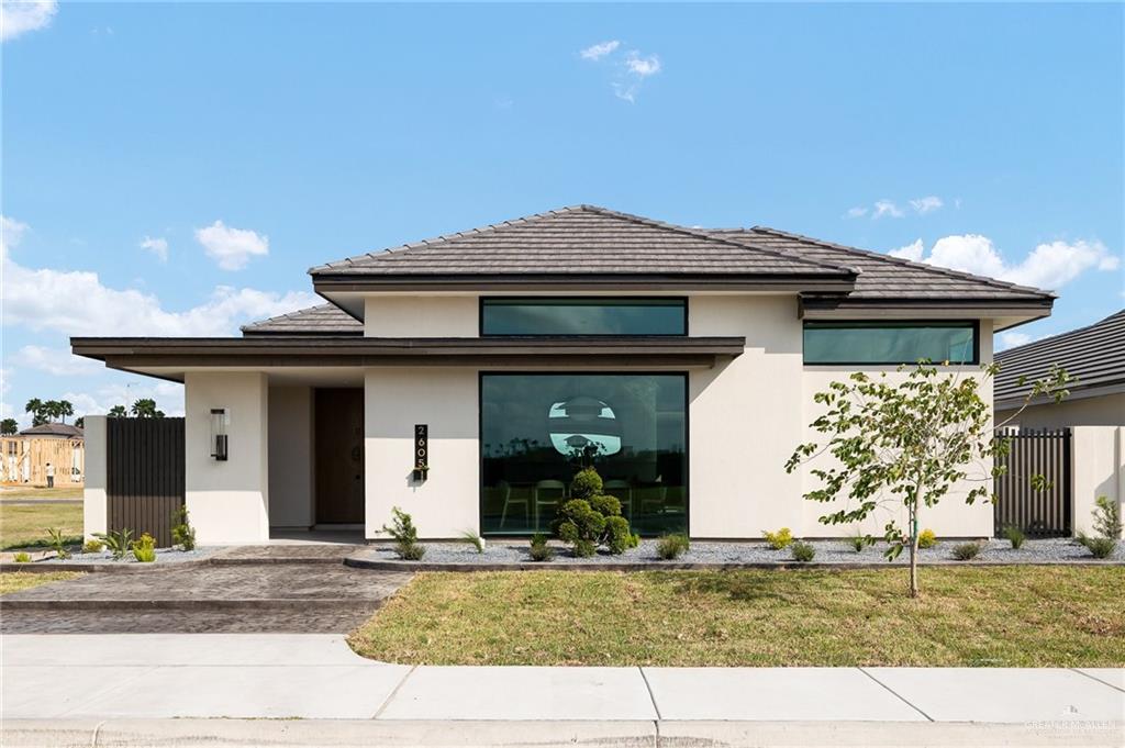 a front view of a house with garden