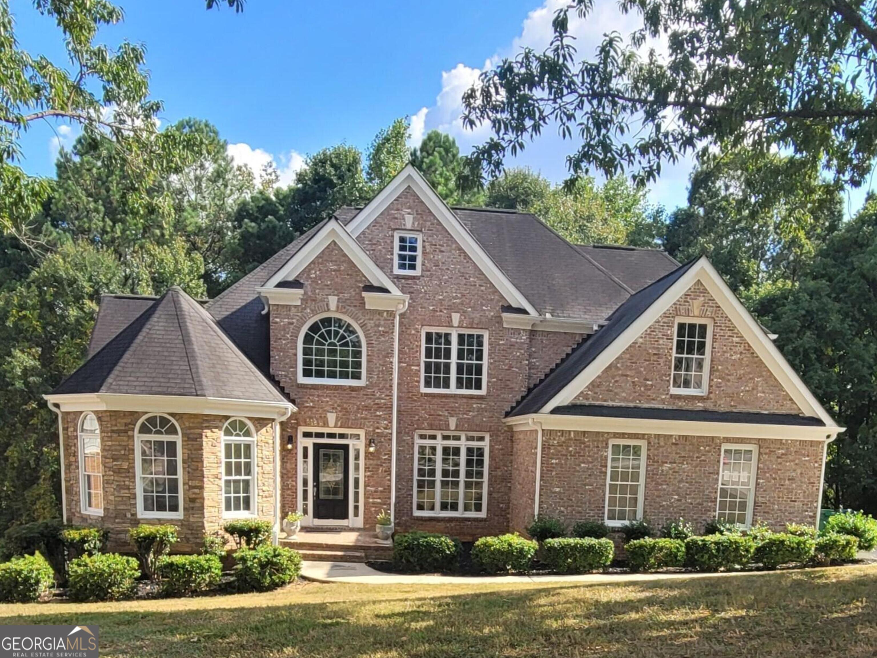 a front view of a house with a yard