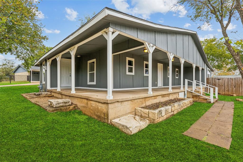 a view of a house with a yard and sitting area