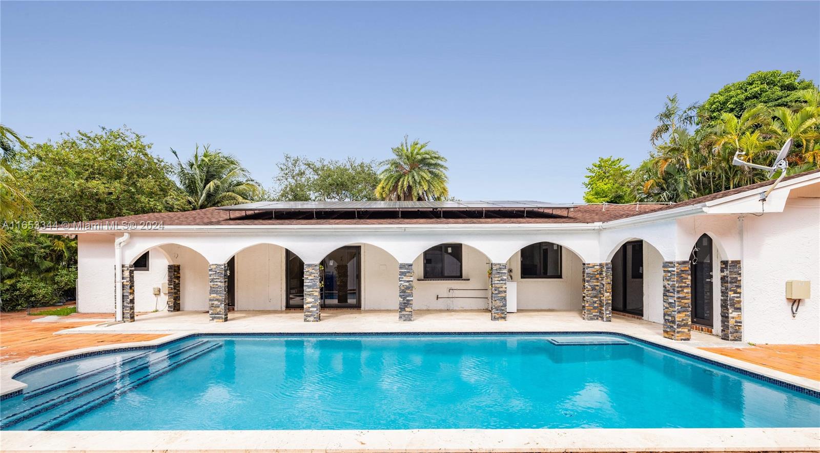 a view of swimming pool with outdoor seating