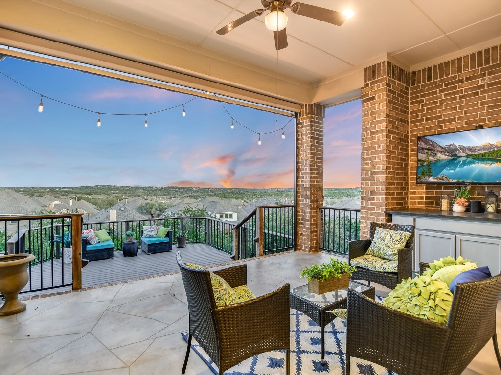 a balcony with furniture and a floor to ceiling window