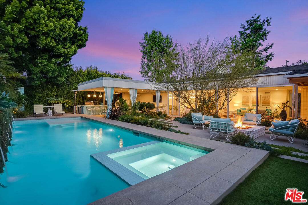 an outdoor space with swimming pool and furniture