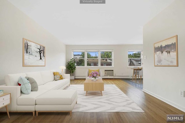 a living room with furniture window and wooden floor