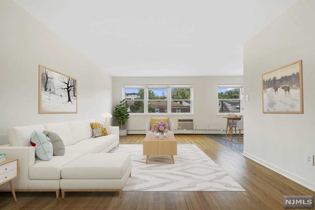 a living room with furniture window and wooden floor