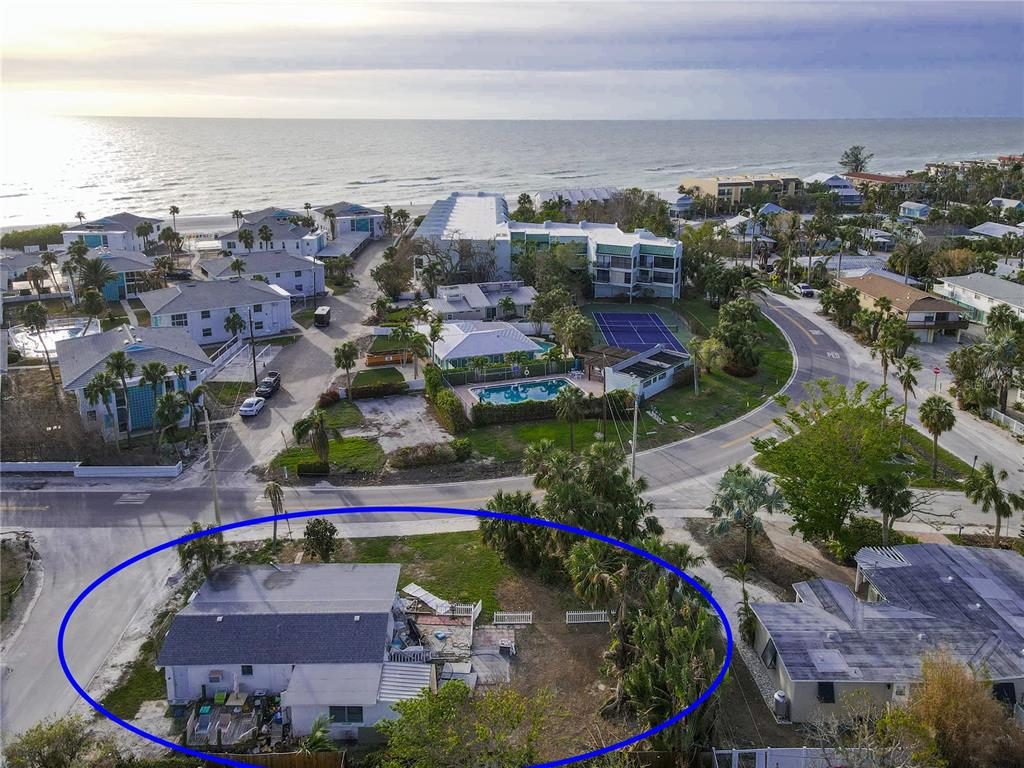 an aerial view of a house with a swimming pool outdoor seating and yard