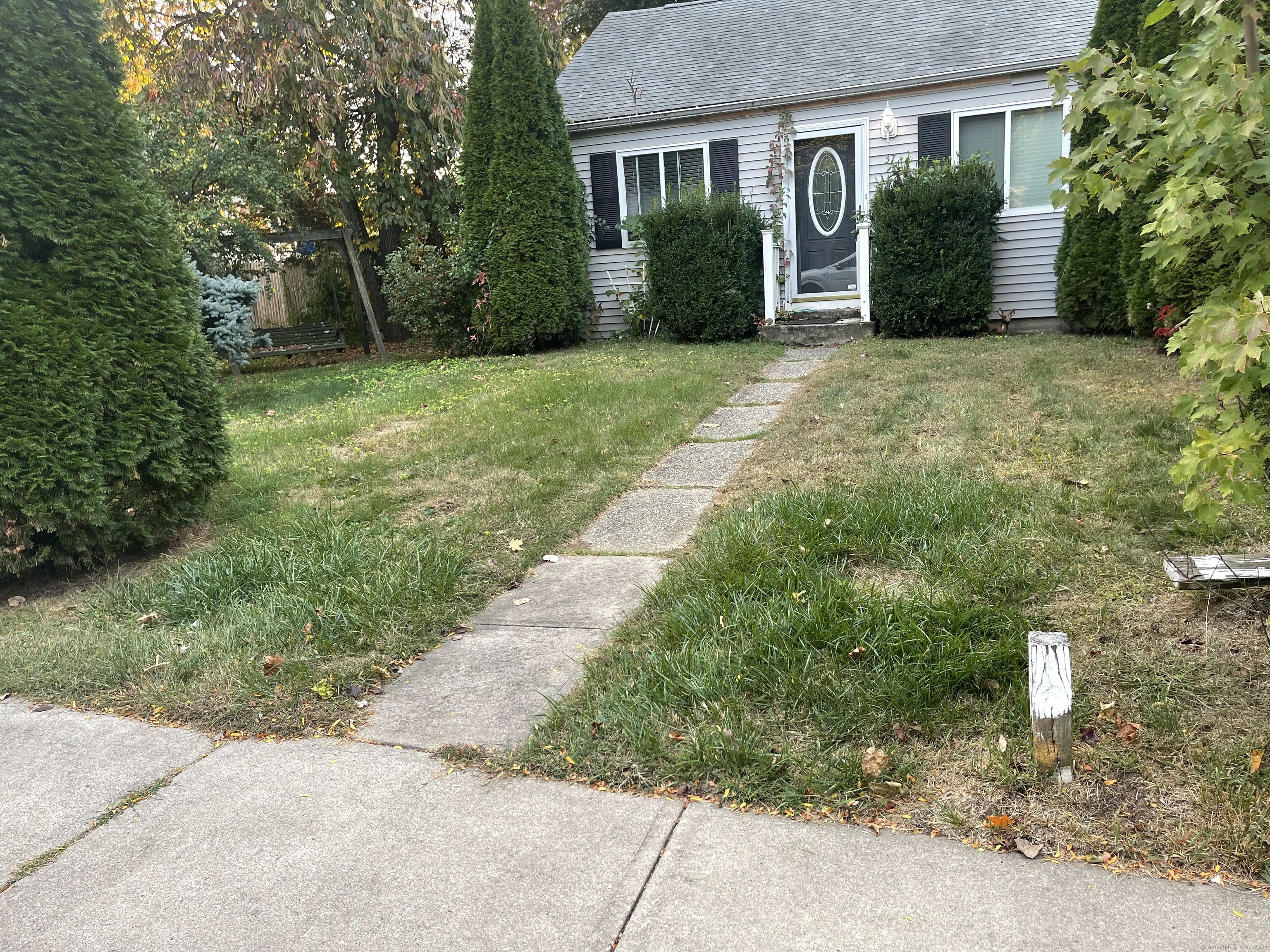 a front view of a house with a garden