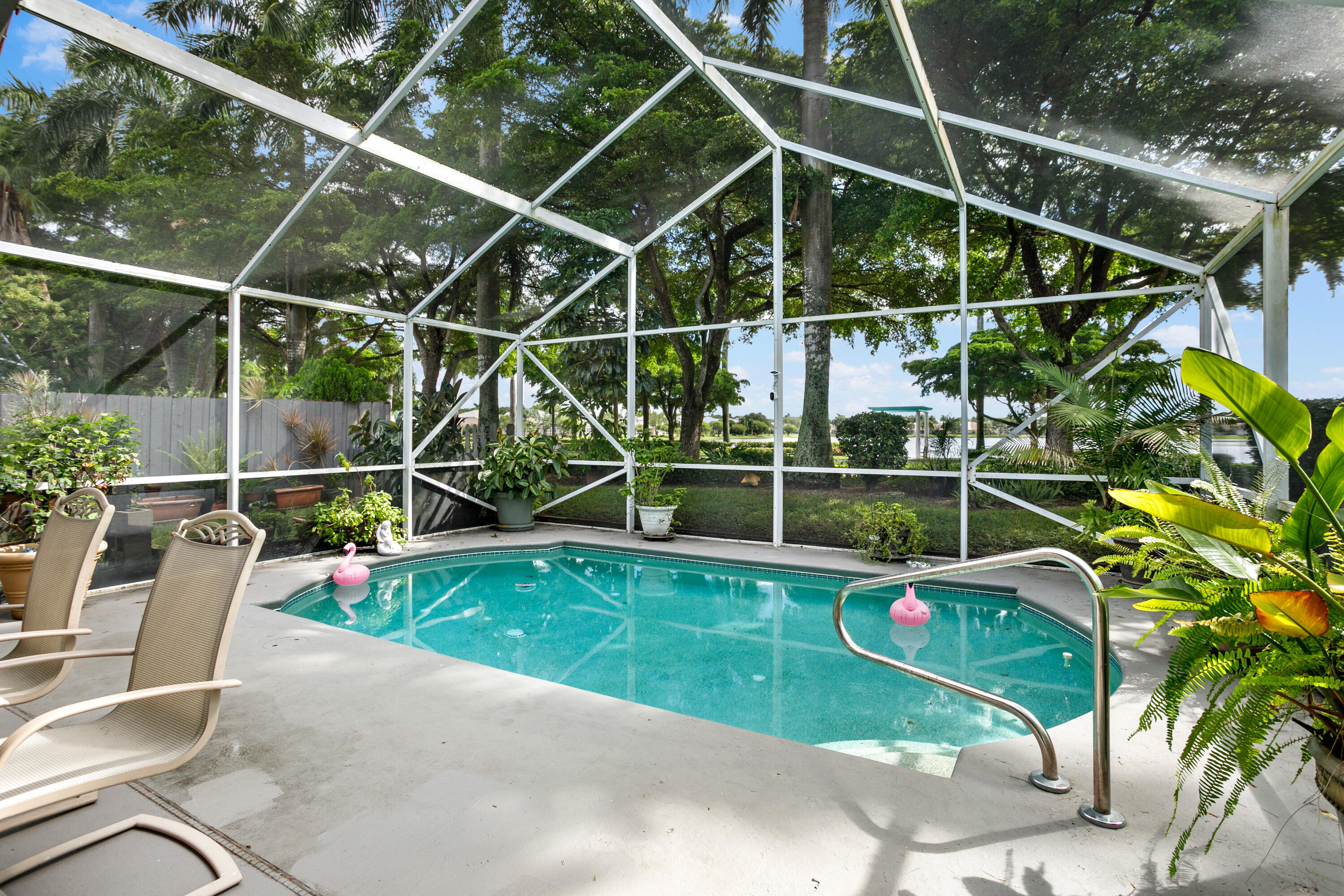 a view of a backyard with swimming pool and couches