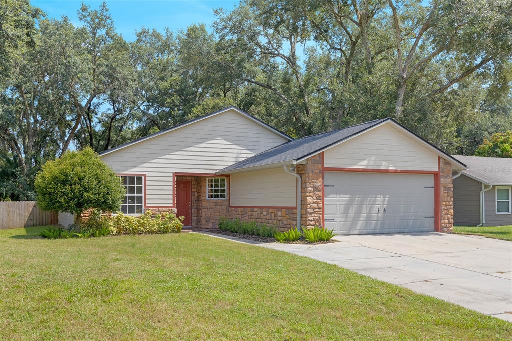 a front view of a house with a yard and garage