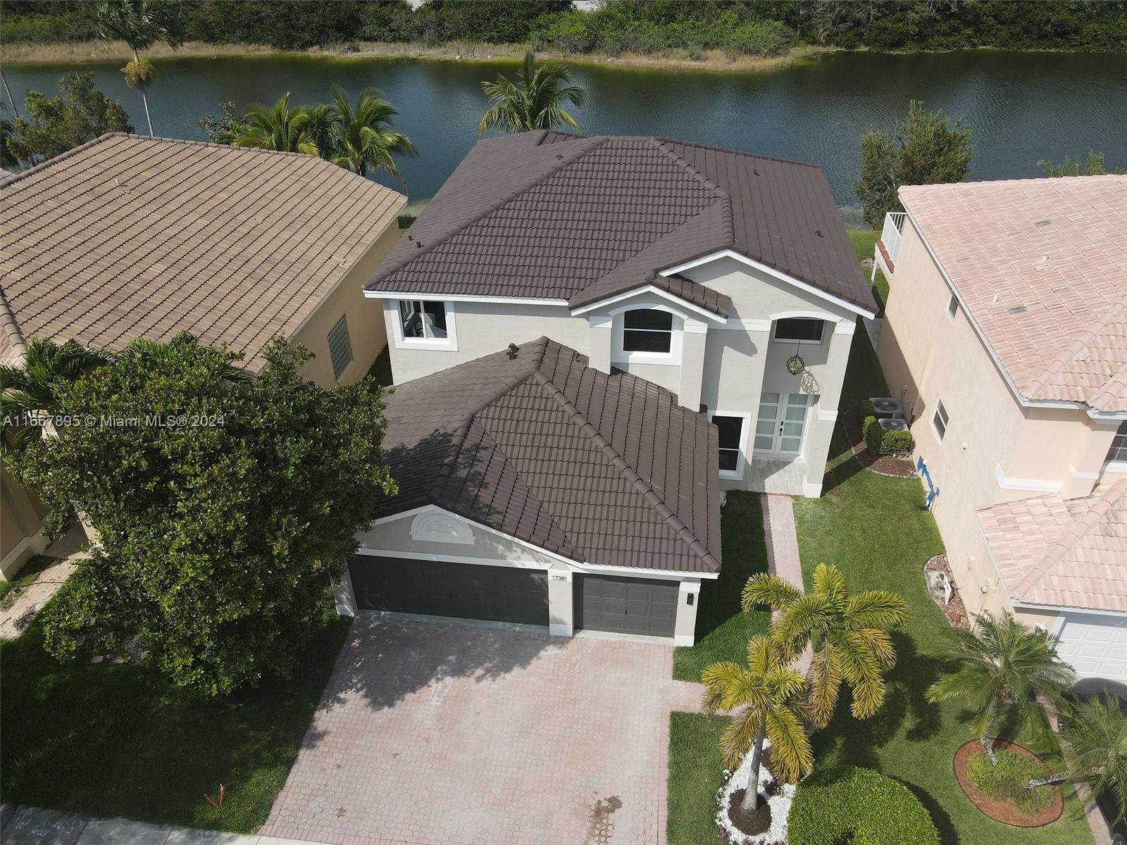 an aerial view of a house with a yard and a potted plant