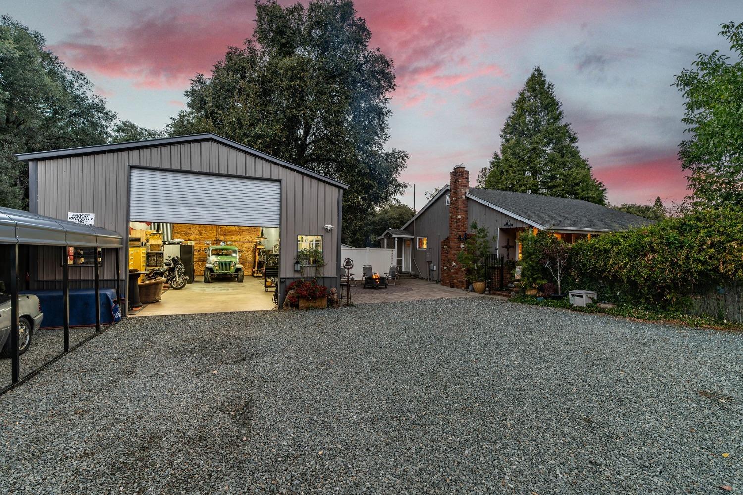 a view of a house with a yard and sitting area