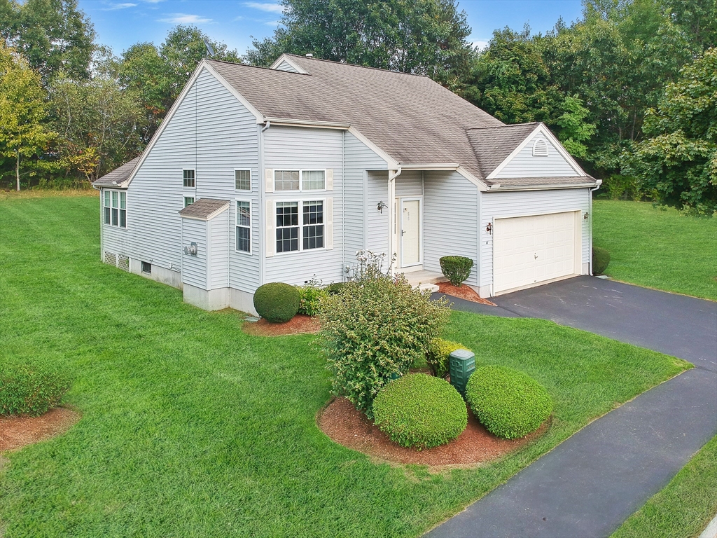 a view of a house with a yard and a garden