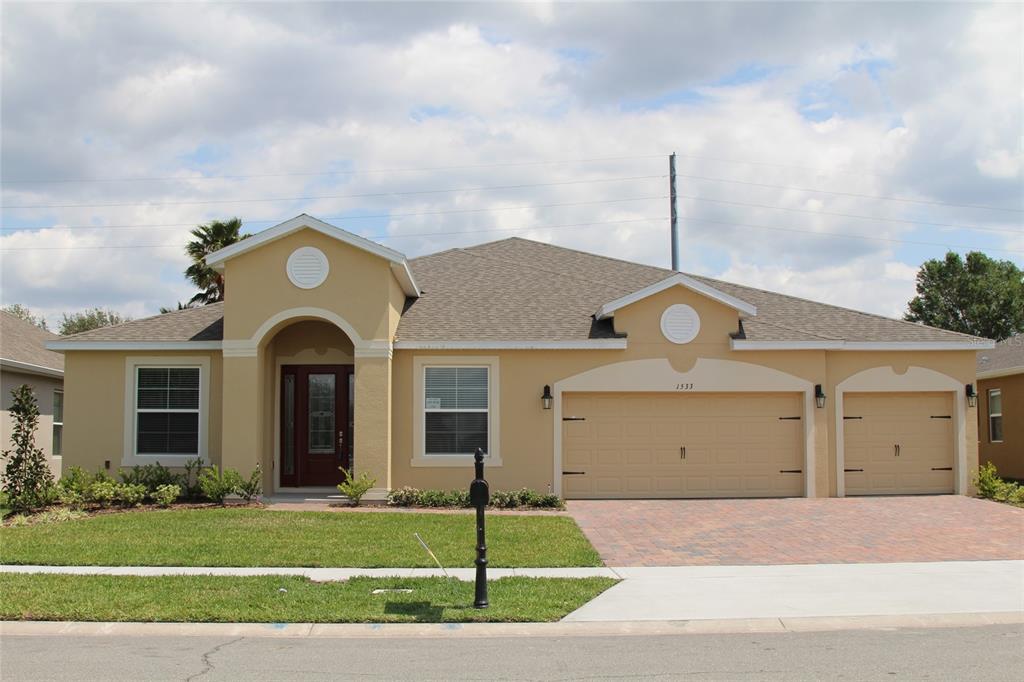 a front view of a house with a garden and entryway