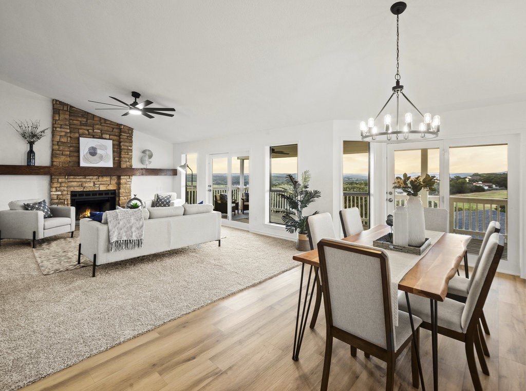 a living room with furniture a chandelier and a large window